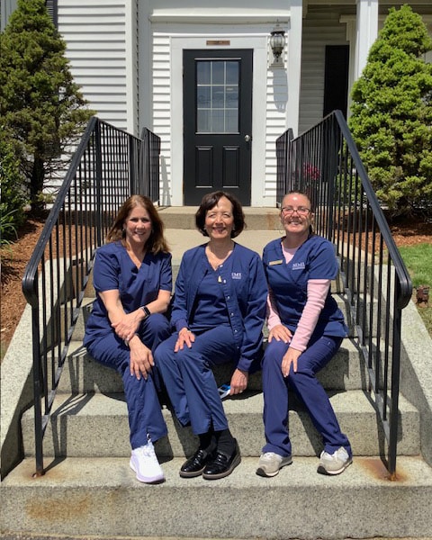 Staff on stairs Simi Orthodontics in Norwood, MA