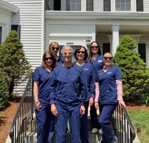 Team on stairs Simi Orthodontics in Norwood, MA